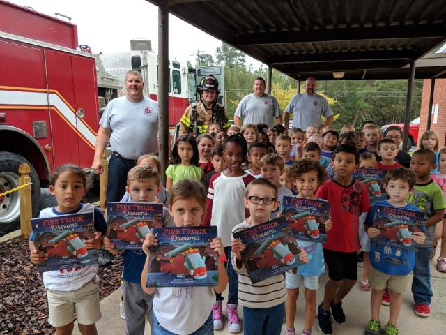 cameron with books and fire truck